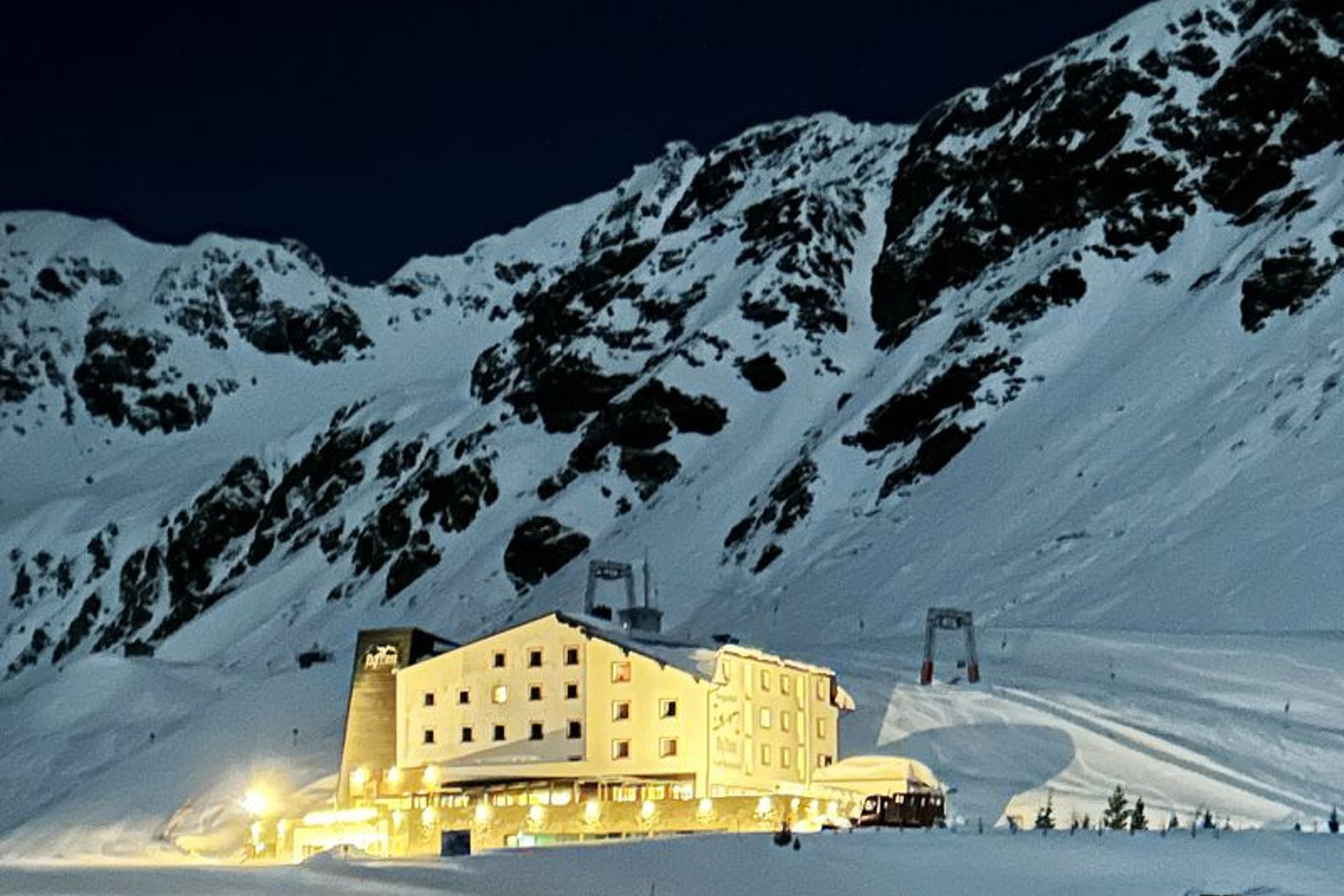 snowy mountains, mountain hotel, ski resort, winter landscape, night scene
