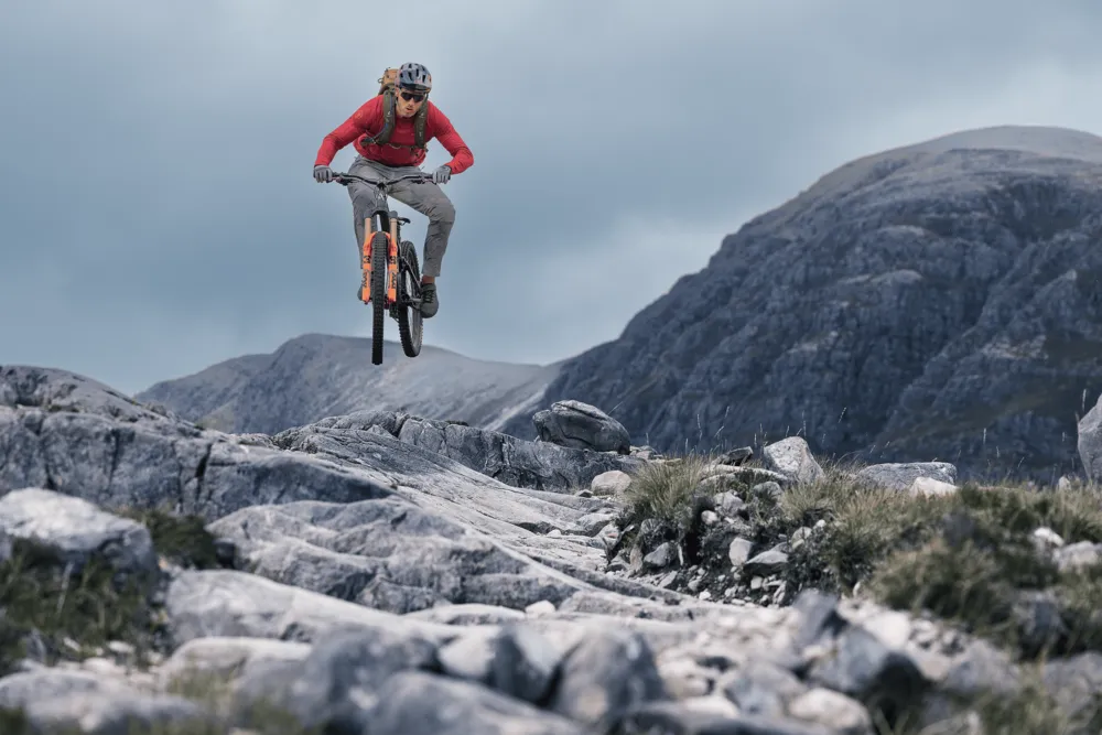 mountain bike, bike rider, gloves, red jacket, outdoor terrain