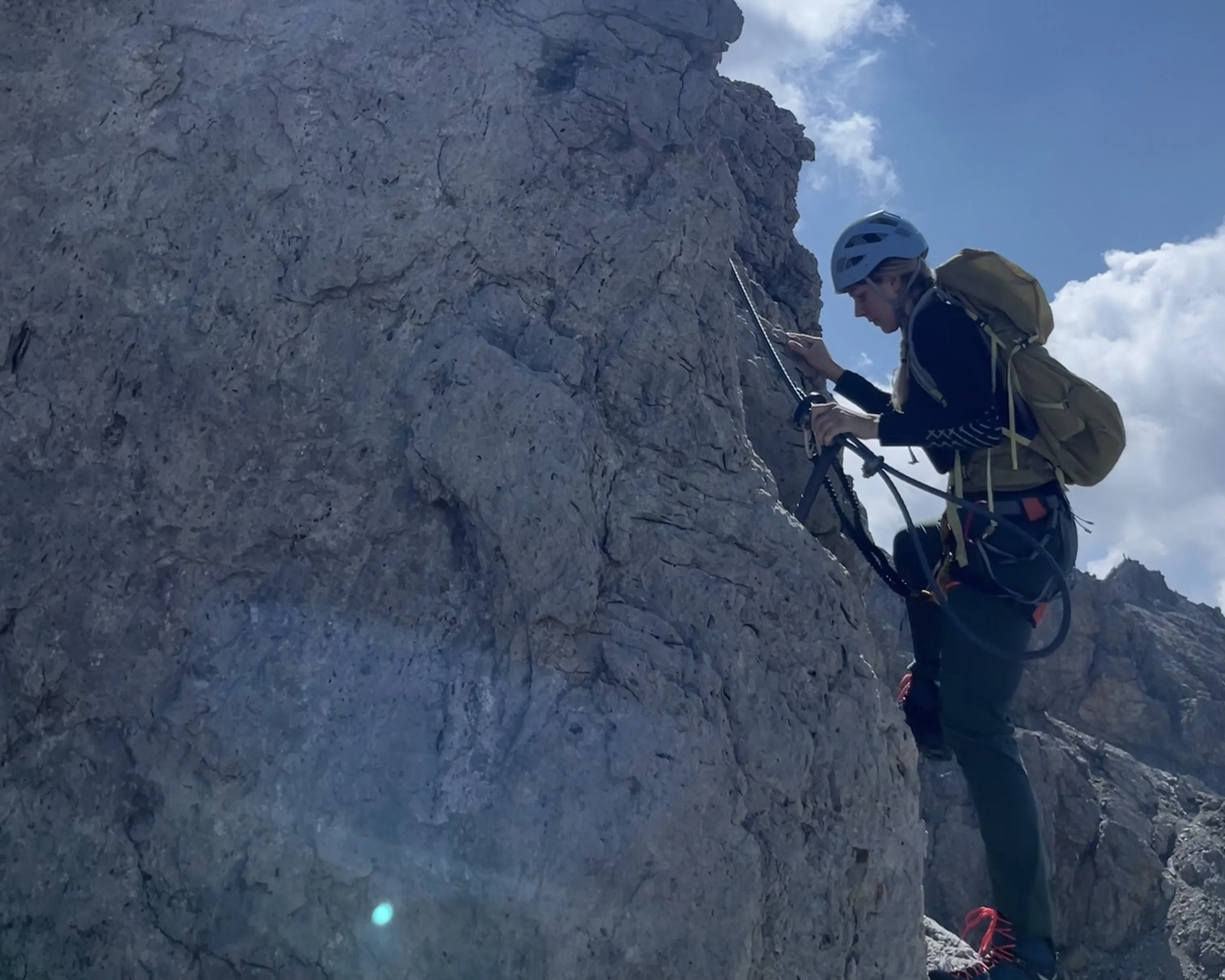 rock_climbing, rocky_cliff, outdoor_activity, helmet, backpack, climbing, rock, mountain, harness, helmet