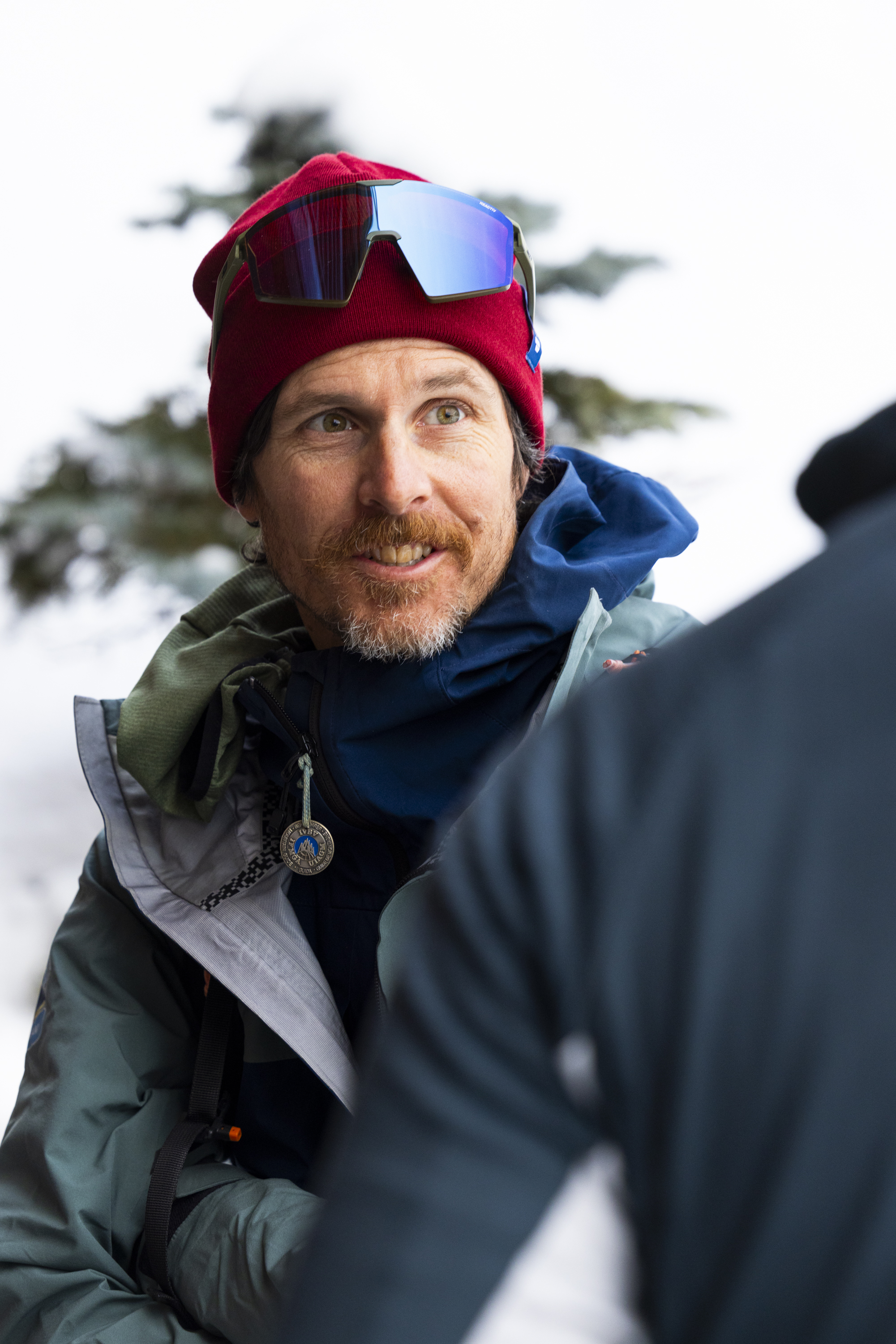 red beanie, ski goggles, mirrored lenses, winter jacket