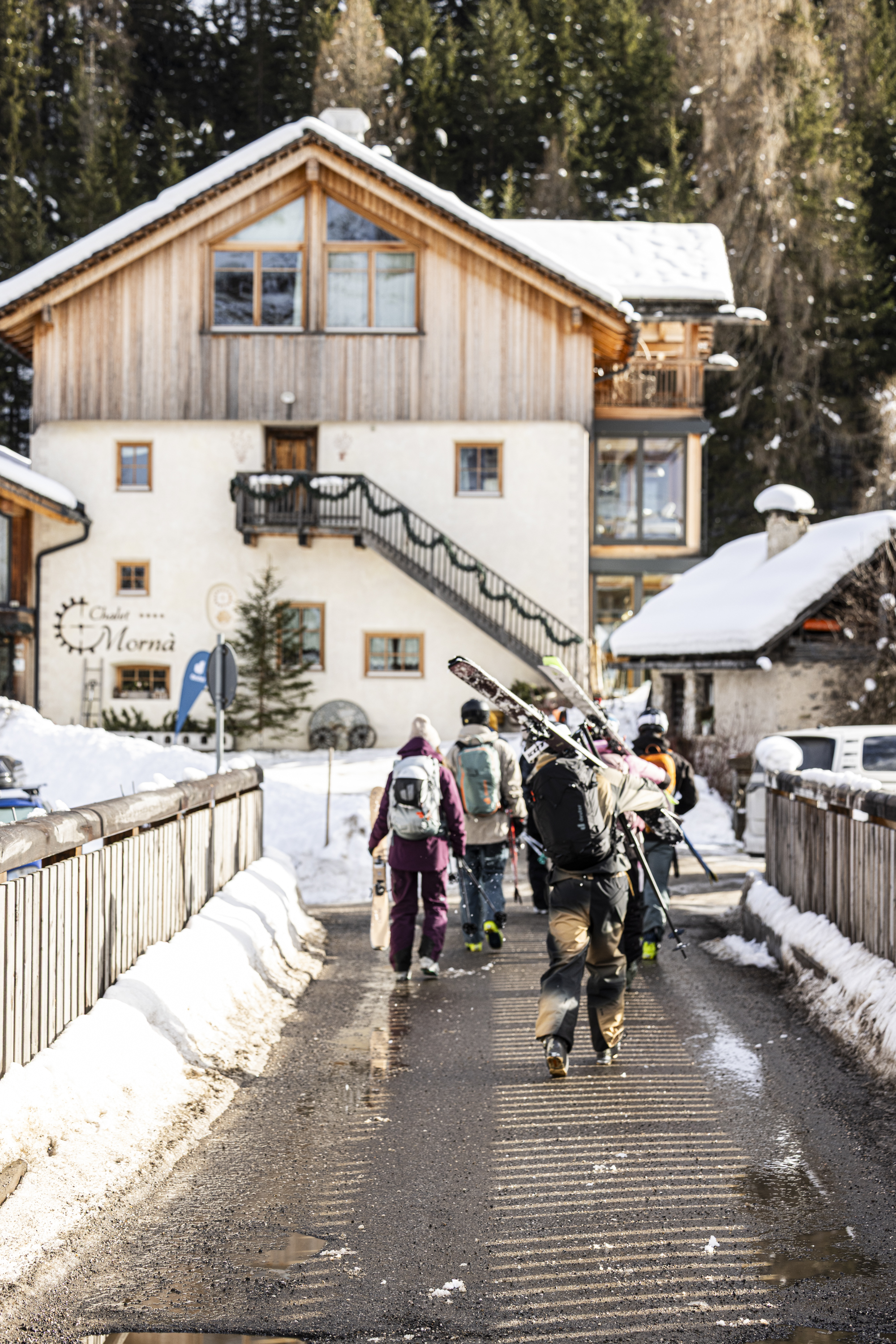 ski resort, wooden chalet, snowy landscape, skis, backpacks