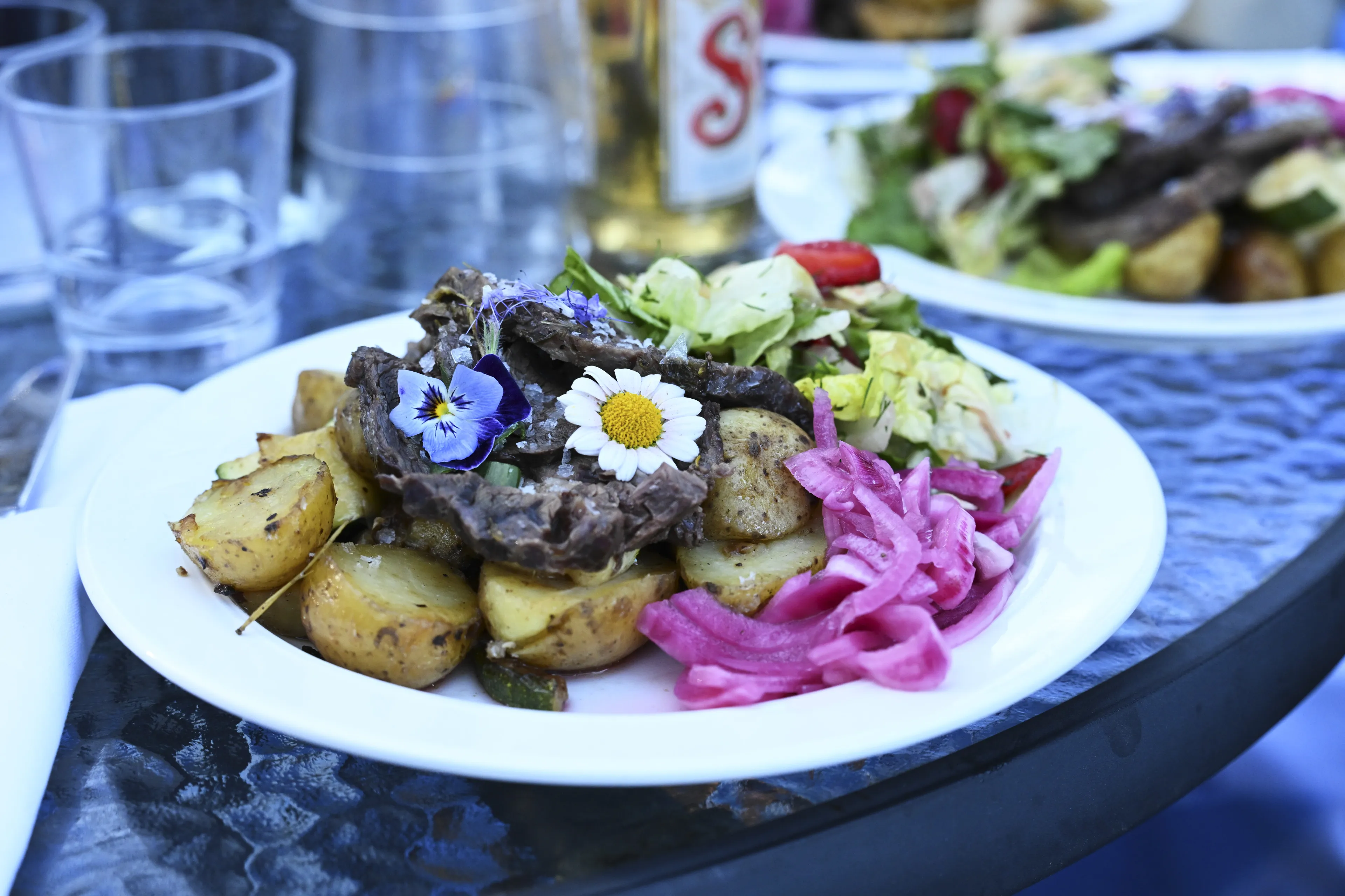 steak, potatoes, salad, edible flowers, pickled onions